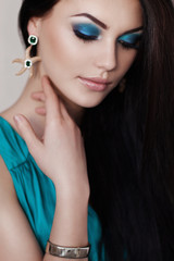 Cute brunette woman in gorgeous emerald dress.