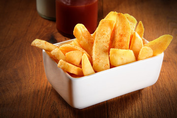 Crispy French Fries on Plate on Wooden Table