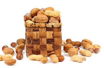 various nuts in a basket on a white background.