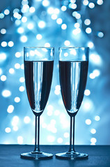wine glasses against Christmas lights