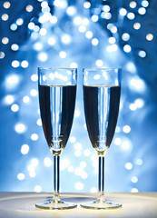 wine glasses against Christmas lights