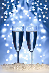 christmas toys, wine glasses against Christmas lights
