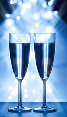 wine glasses against Christmas lights