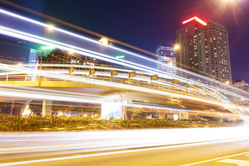 Fototapeta na wymiar Traffic blur motion trails in modern city street at night