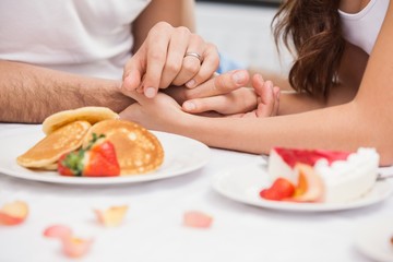 Obraz na płótnie Canvas Close up of young couple having a romantic breakfast