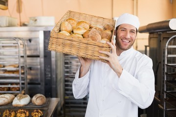Baker holding basket of bread - 77983676