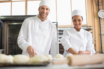 Team of bakers preparing dough