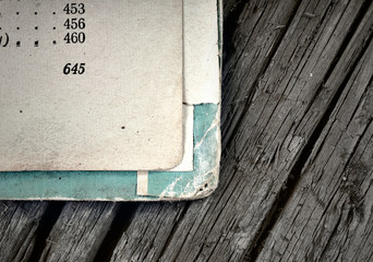 Open pages of old shabby books on a background of aged wood faci