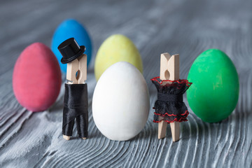 Easter concept. Man, woman and colorful easter eggs.