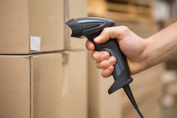 Worker holding scanner in warehouse