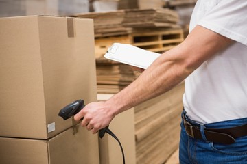 Worker using scanner in warehouse