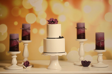 white cake with purple candles