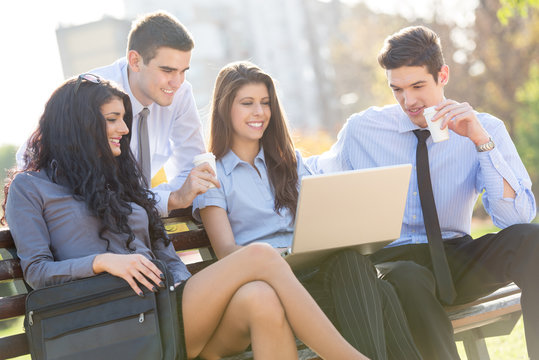 Young Business People On Park Bench