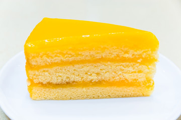 fresh piece of orange cream cake