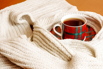 Cup of hot tea and scarf