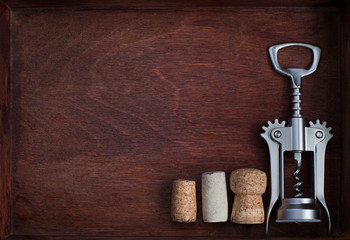 Corkscrew and wine corks into dark box
