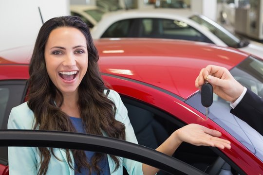 Excited woman receiving car key