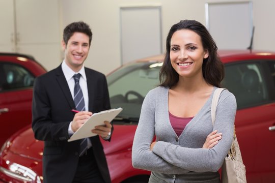 Smiling businessman undersign a car contract
