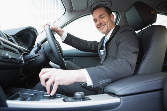 Smiling businessman in the drivers seat