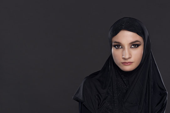 Portrait of a beautiful Muslim woman dressed in black hijab