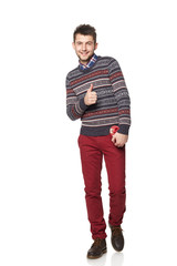 Young man with a heart-shaped gift isolated on white background.