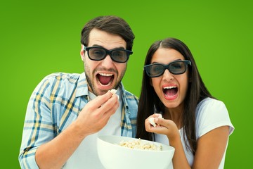 Composite image of attractive young couple watching a 3d movie
