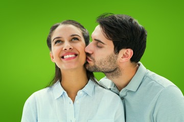 Composite image of handsome man kissing girlfriend on cheek
