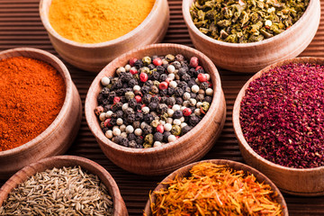 dry spices in a wooden bowl close-up