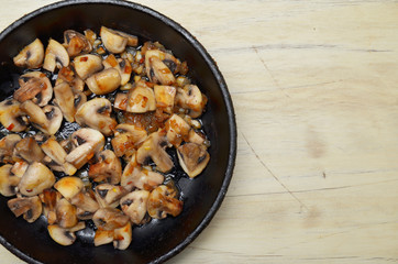 Delicious fried mushrooms in pan on table