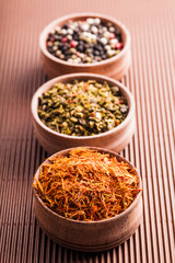 set dry spices pepper,saffron,paprika in a wooden bowl
