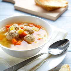 Soup with meatballs and vegetables in a bowl