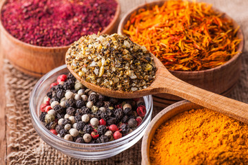 dry spices in a wooden and glass bowls close-up