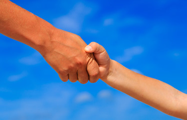 mother and son holding hands on sky