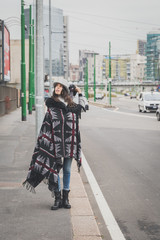 Beautiful young brunette posing in the city streets