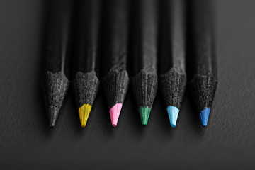 black, colored pencils, on black background