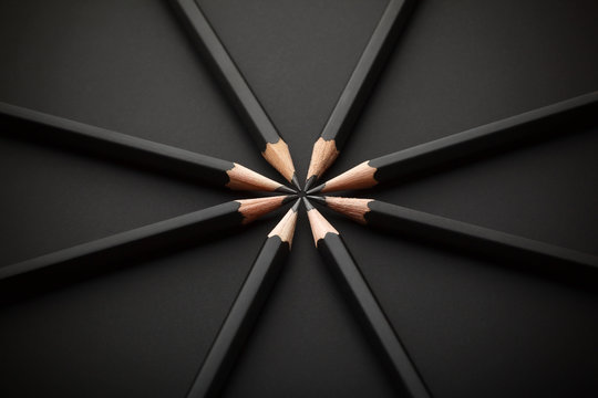 Set of black pencils on black background