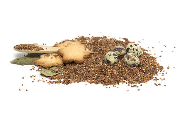 Buckwheat on a wooden spoon and egg. Photo.
