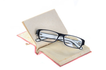 Open mulberry notebook and eyeglasses isolated on white.