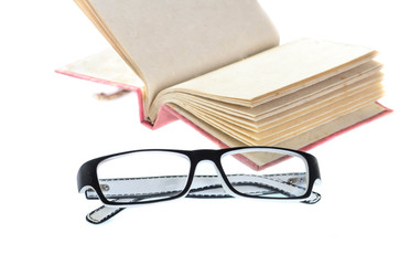 Open mulberry notebook and eyeglasses isolated on white.