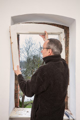 Carpenter removing an old window