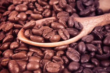 roasted coffee beans in wooden spoon, selective focus