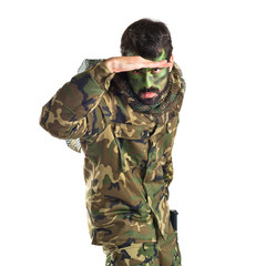 Soldier showing something over white background