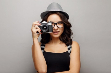 Beautiful girl in a hat with camera.