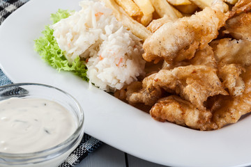 Fish and chips with tartar sauce on a plate