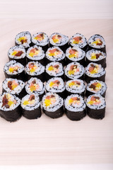 sushi fresh maki rolls isolated on wooden board