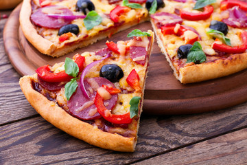 Delicious pizza served on wooden table