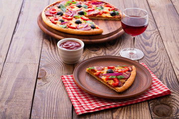 Delicious pizza served on wooden table