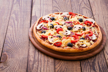 Pizza with seafood on wood desk