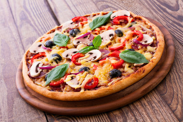 Pizza with seafood on wood desk