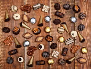 Chocolates on the wooden table.